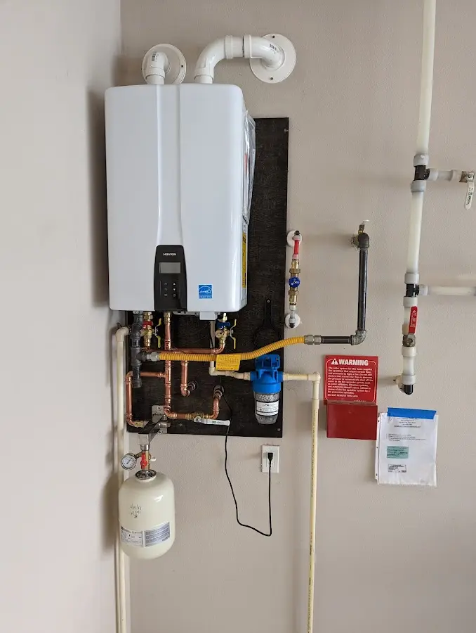Professional plumber installing copper piping in a Loris home